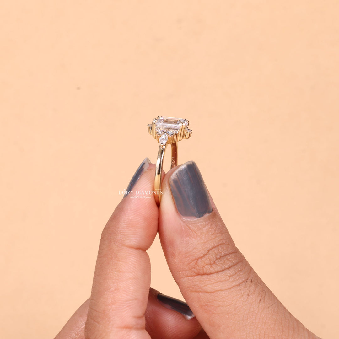 Angled view of emerald cut diamond in cluster setting