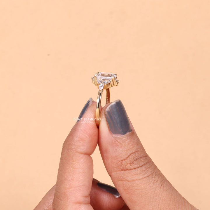 Angled view of emerald cut diamond in cluster setting