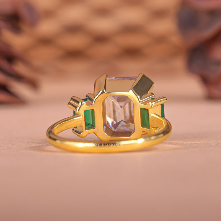 Premium emerald cut three stone engagement ring crafted in solid gold