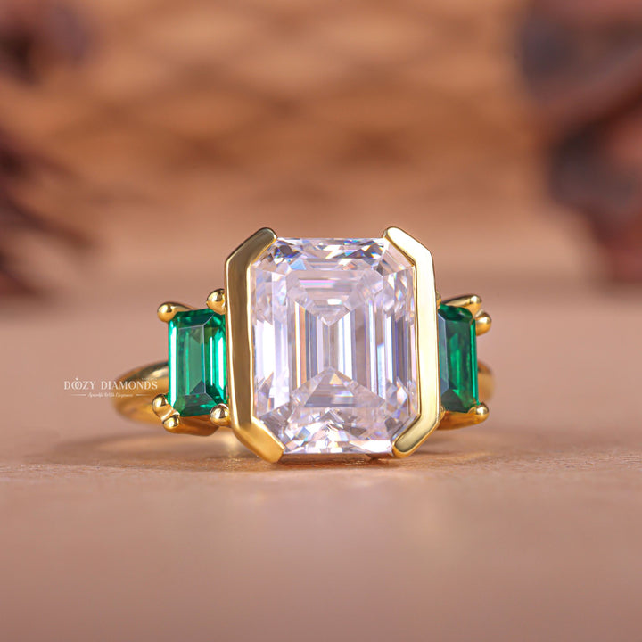 Unboxing view of emerald cut three stone diamond engagement ring