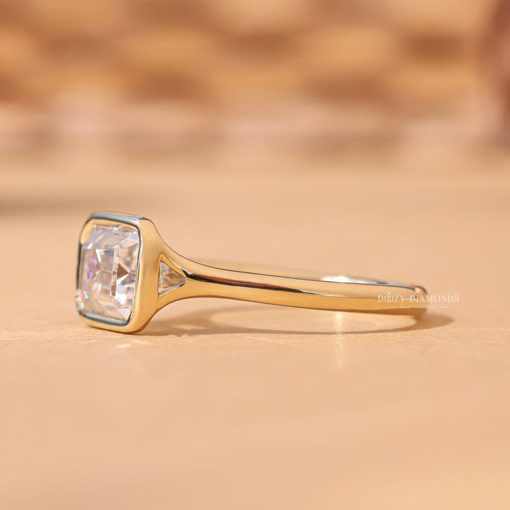 Emerald bezel engagement ring viewed from the side