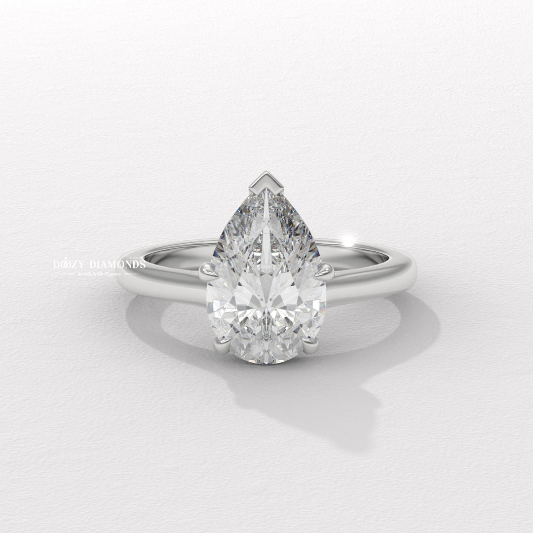 Pear solitaire engagement ring close-up highlighting diamond sparkle
