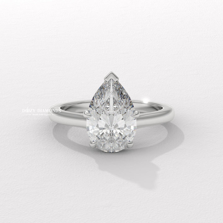 Pear solitaire engagement ring close-up highlighting diamond sparkle