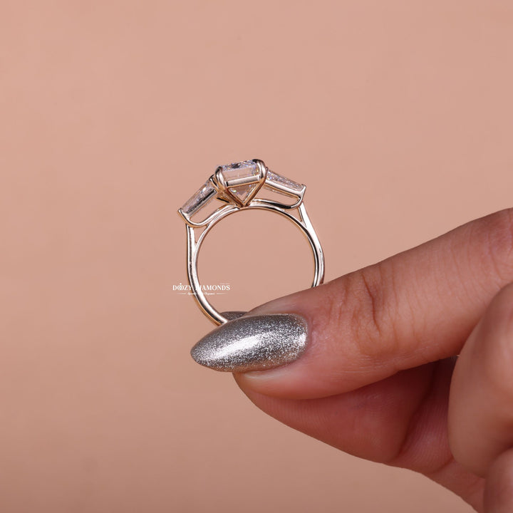 Emerald three stone lab grown diamond ring fitted on finger