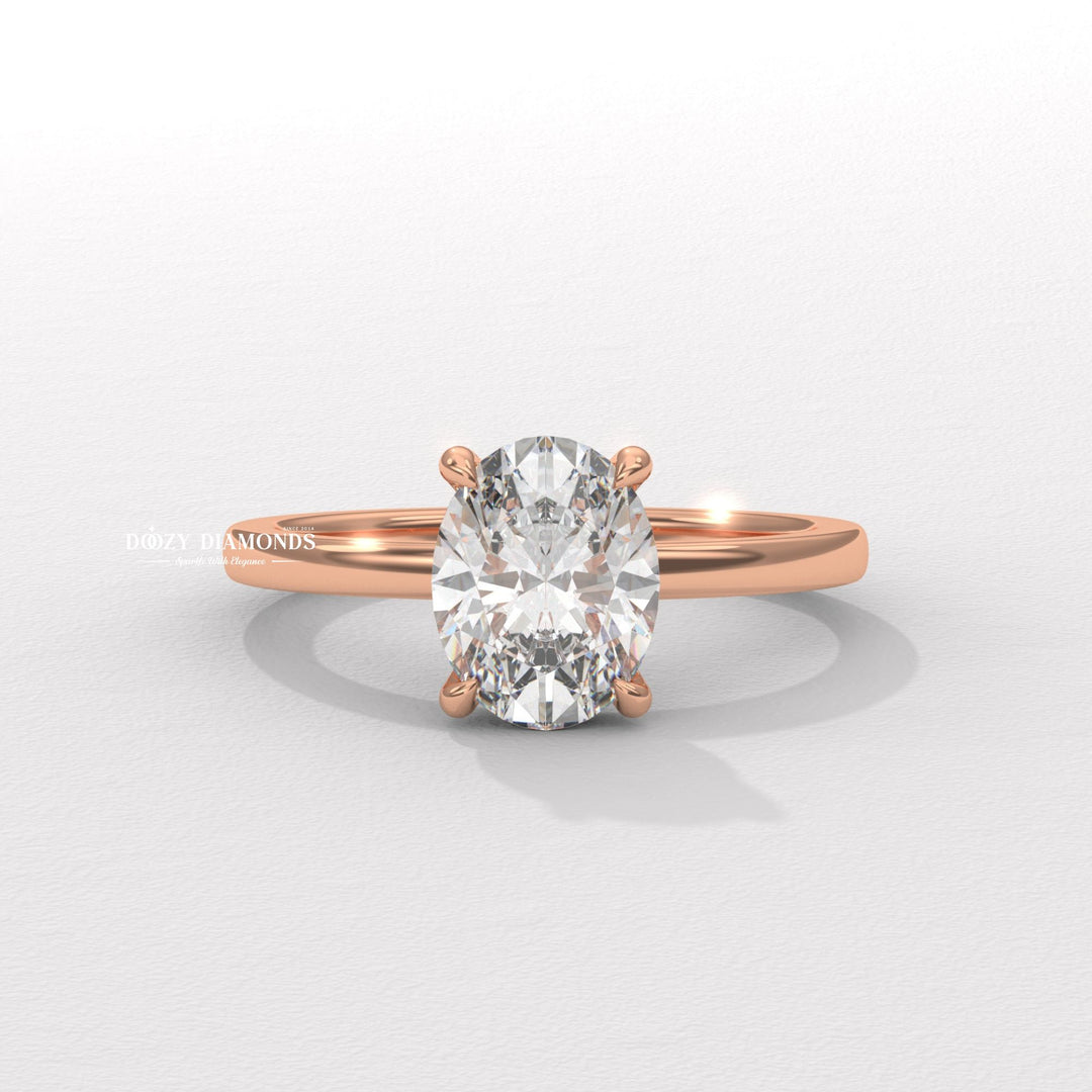 Oval solitaire engagement ring shown on hand for true-to-life sizing