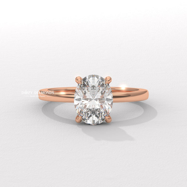 Oval solitaire engagement ring shown on hand for true-to-life sizing