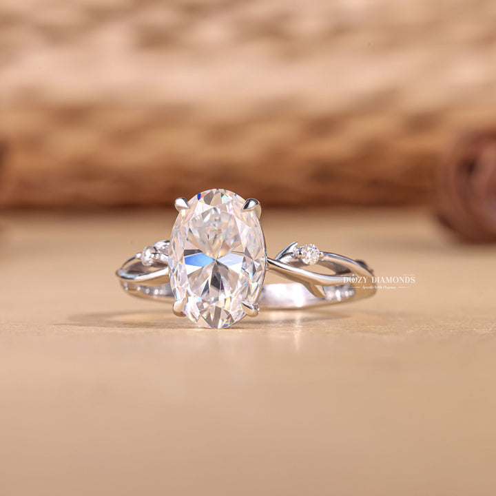 Oval solitaire diamond ring displayed on jewelry stand