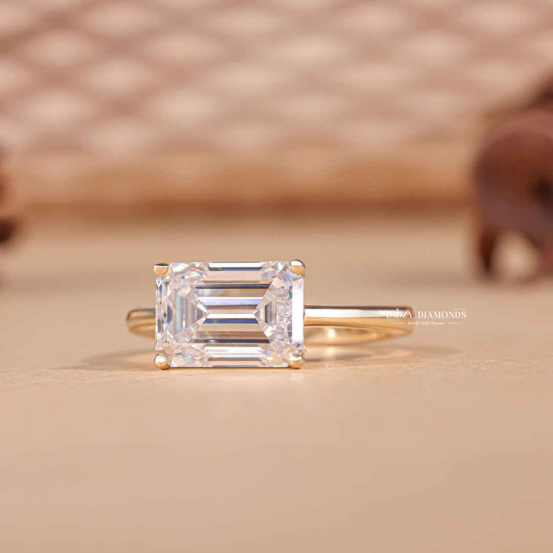 Profile view of emerald cut east west engagement ring band
