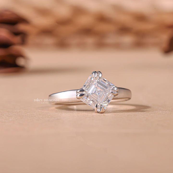 Lifestyle shot of asscher solitaire diamond ring on hand