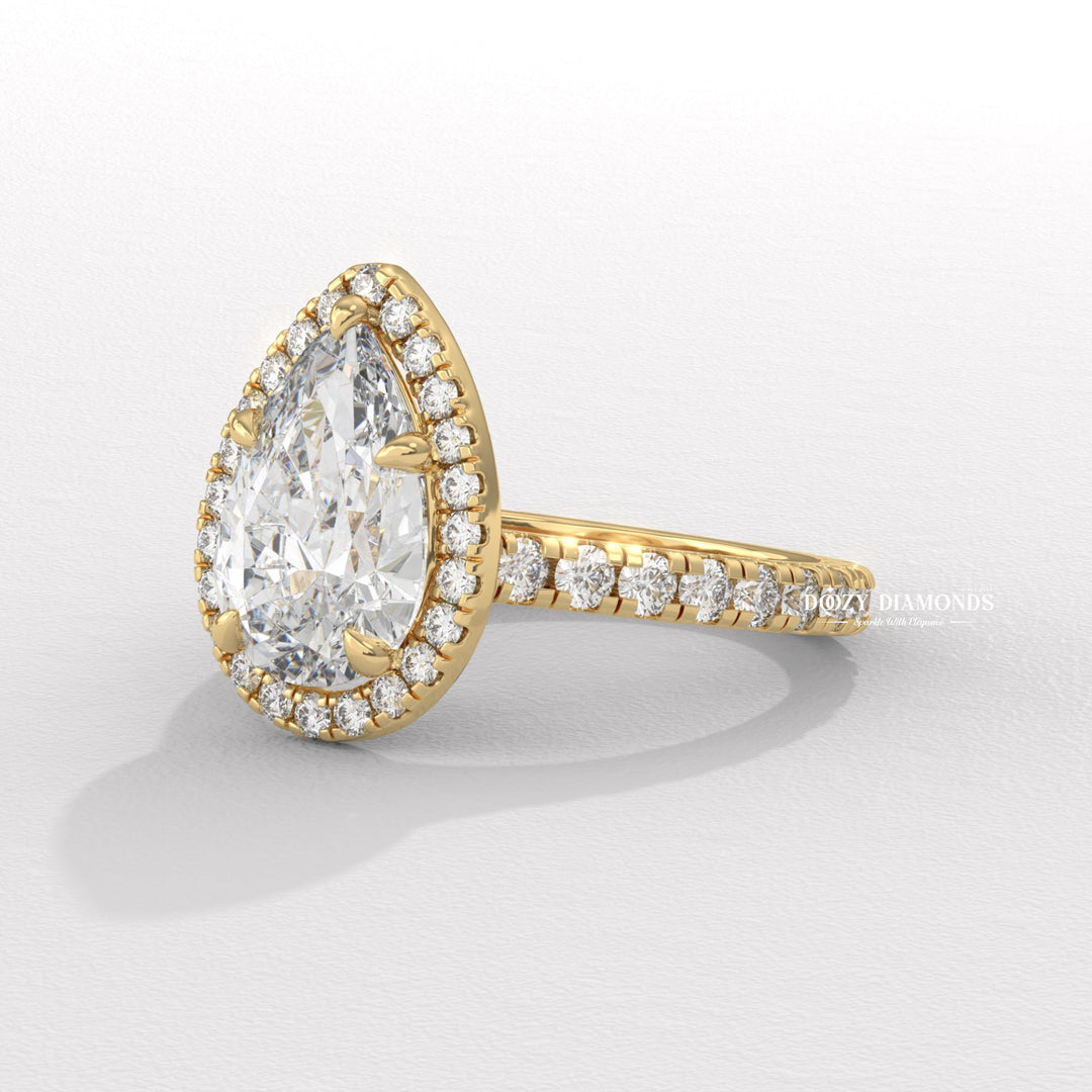 Certified pear cut diamond featured in halo engagement ring