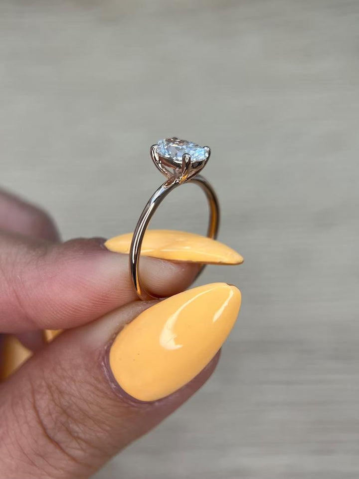Oval hidden halo diamond ring presented in signature gift packaging