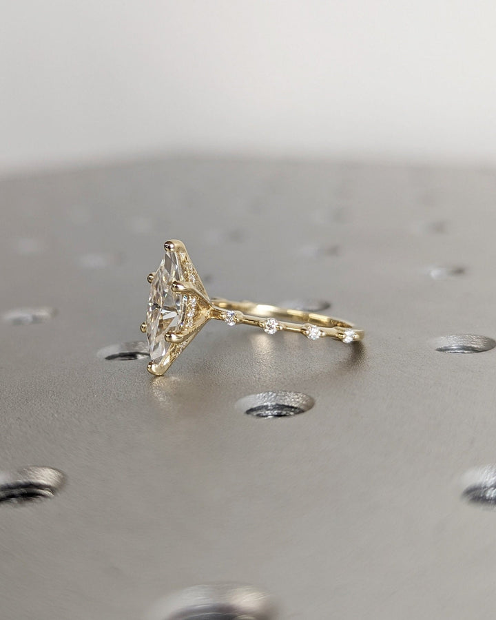 Marquise hidden halo diamond ring displayed on jewelry stand