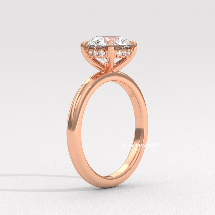 Round hidden halo engagement ring photographed in natural light