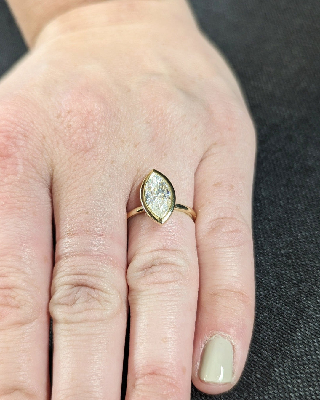 Marquise bezel engagement ring with brilliant diamond sparkle