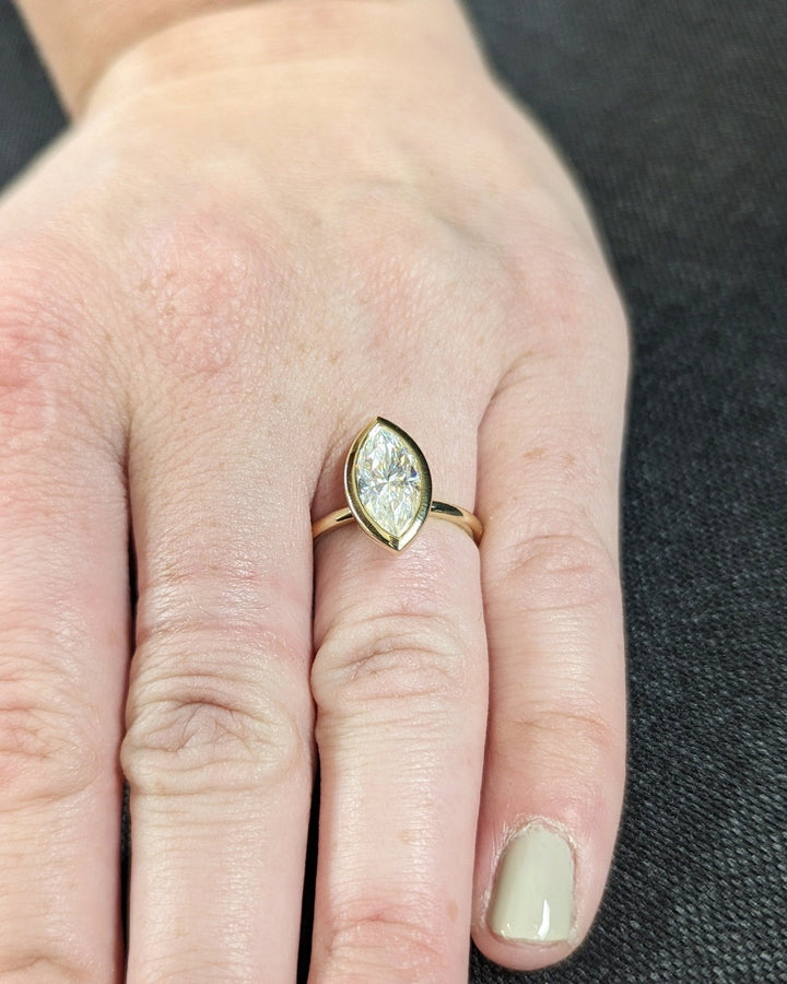 Marquise bezel engagement ring with brilliant diamond sparkle