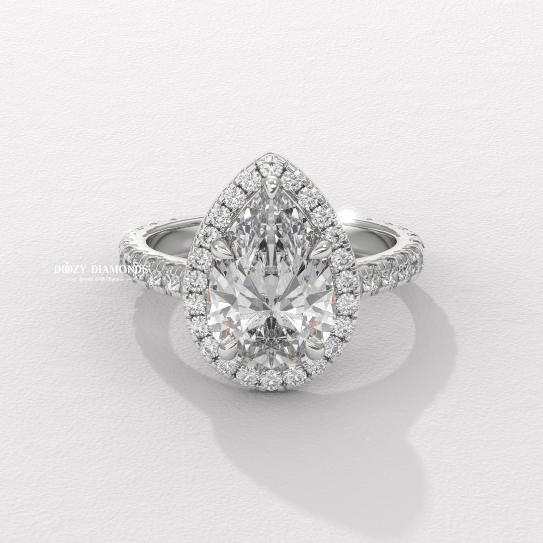 Pear halo engagement ring offered in gold and platinum