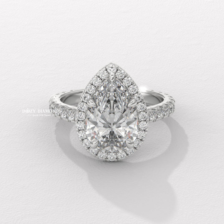Pear halo engagement ring offered in gold and platinum