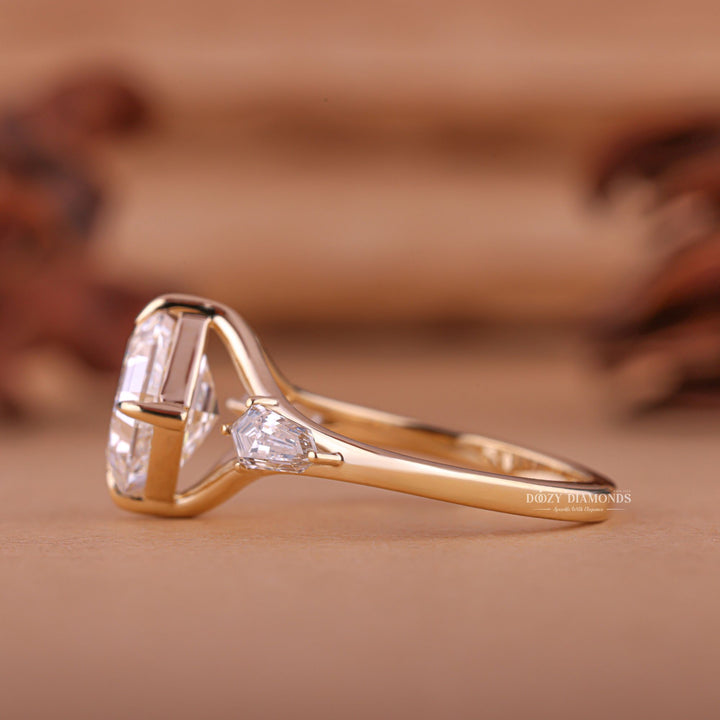 Angled view of asscher cut diamond in three stone setting