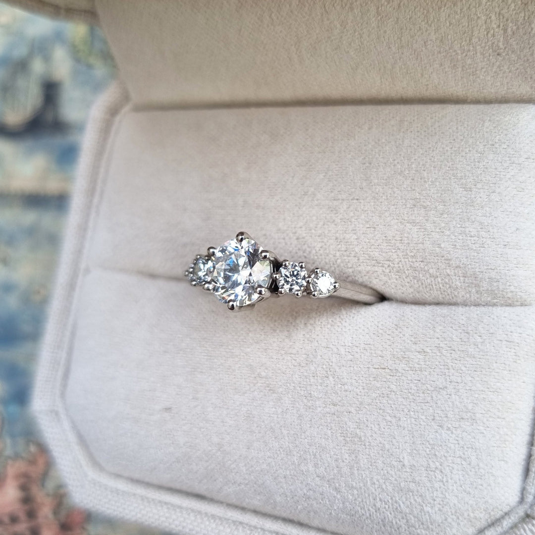 Round five stone diamond ring presented in signature gift packaging