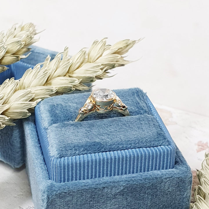 Round bezel engagement ring photographed in natural light