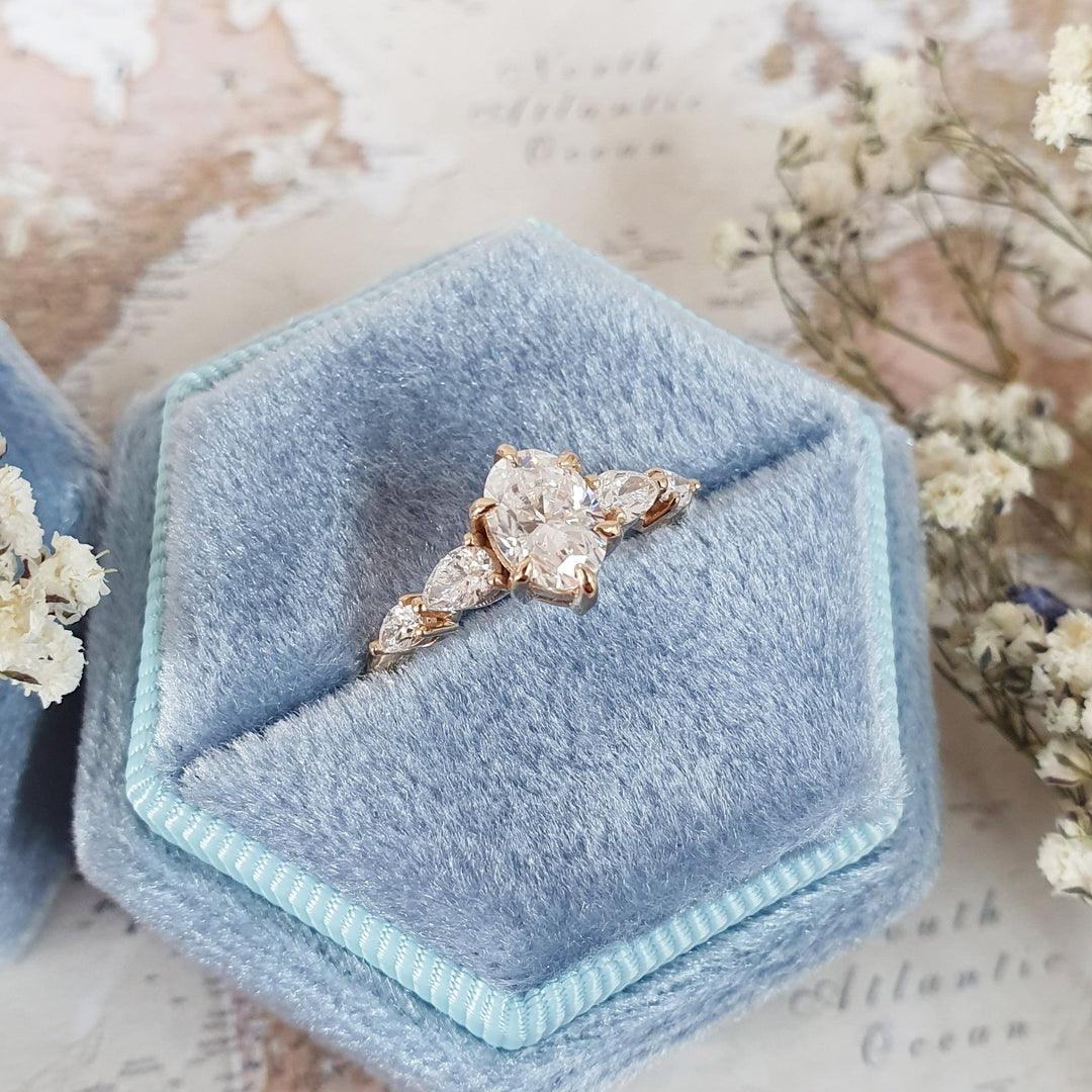 Angled view of oval cut diamond in five stone setting