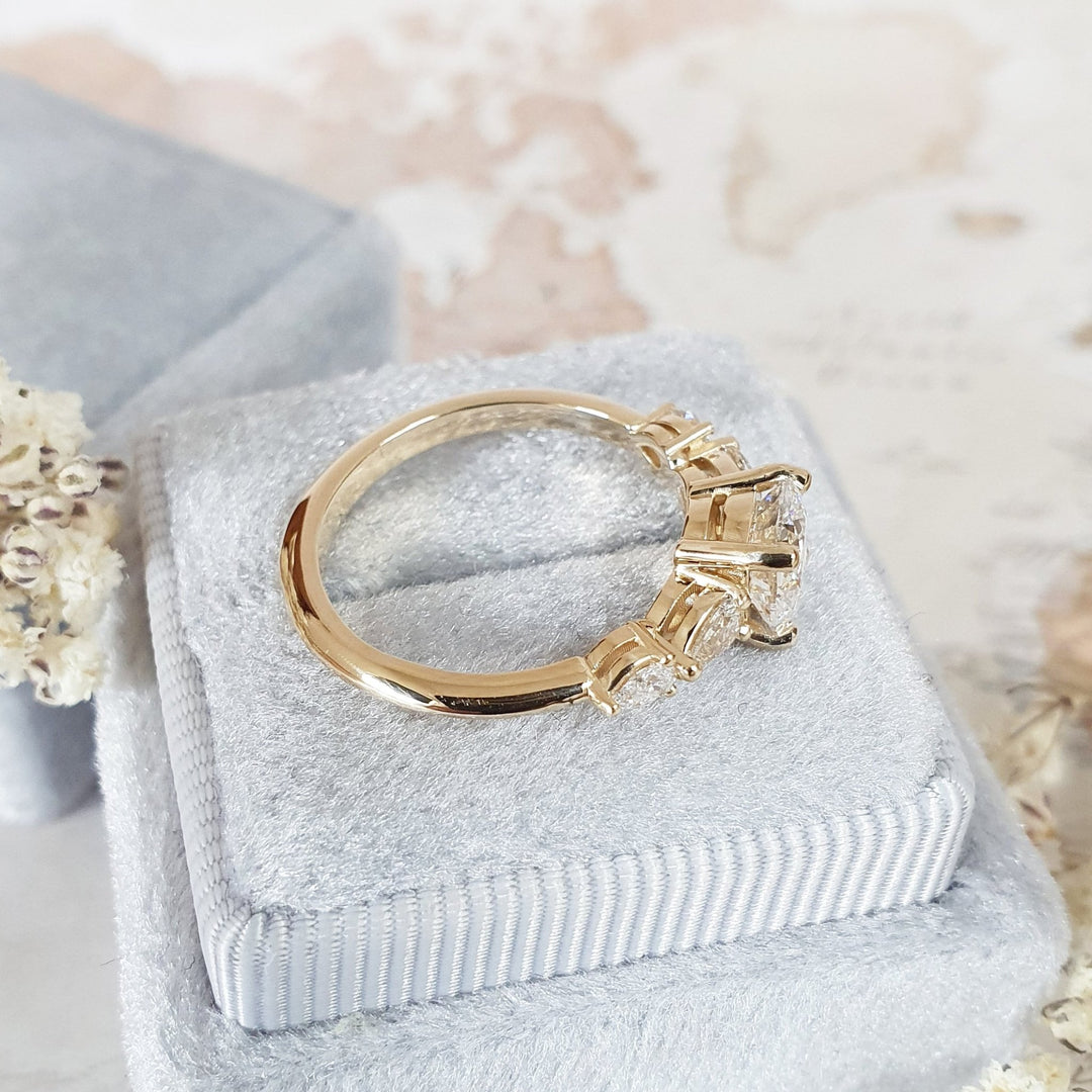 Round cut five stone engagement ring shown in real-life wear