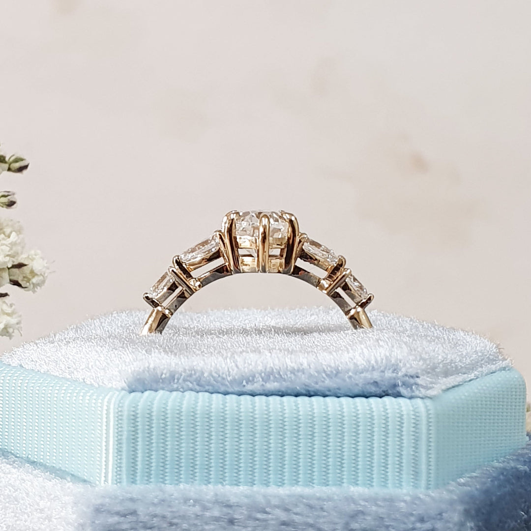 Oval five stone engagement ring close-up showing G/VS2 diamond clarity
