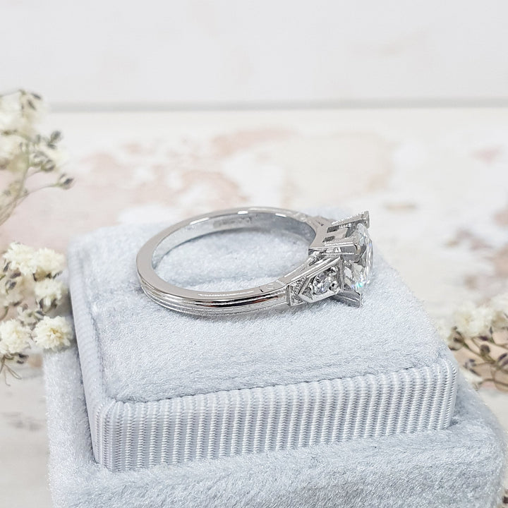 Fine craftsmanship detail on round three stone engagement ring