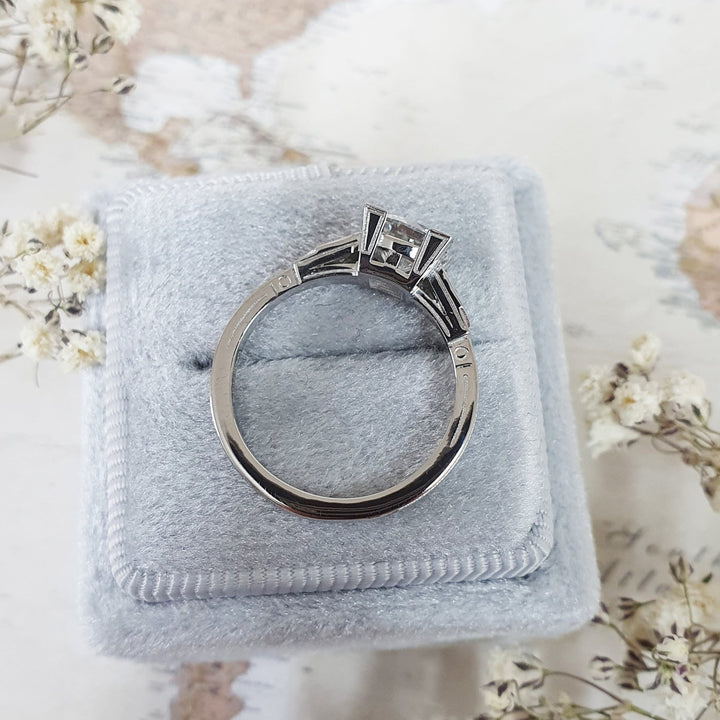 Round three stone engagement ring finished in polished solid gold