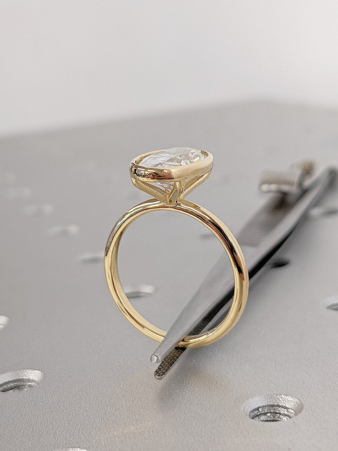 Oval bezel engagement ring with certified lab grown diamond