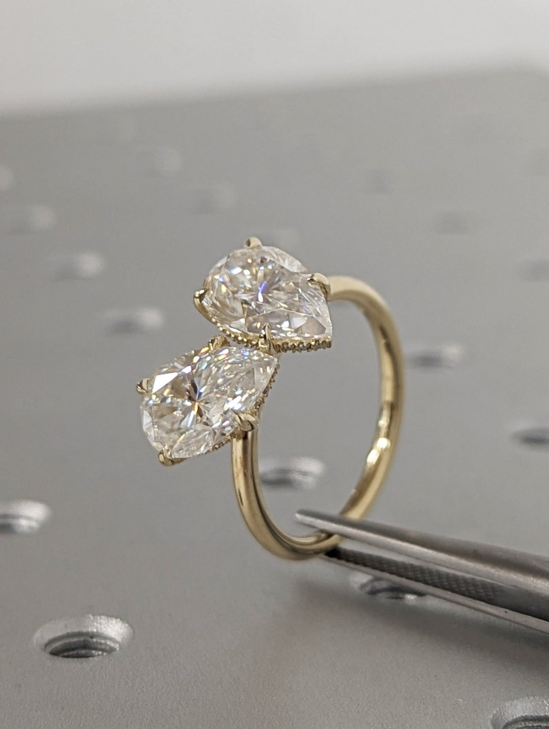 Pear hidden halo engagement ring viewed from the side