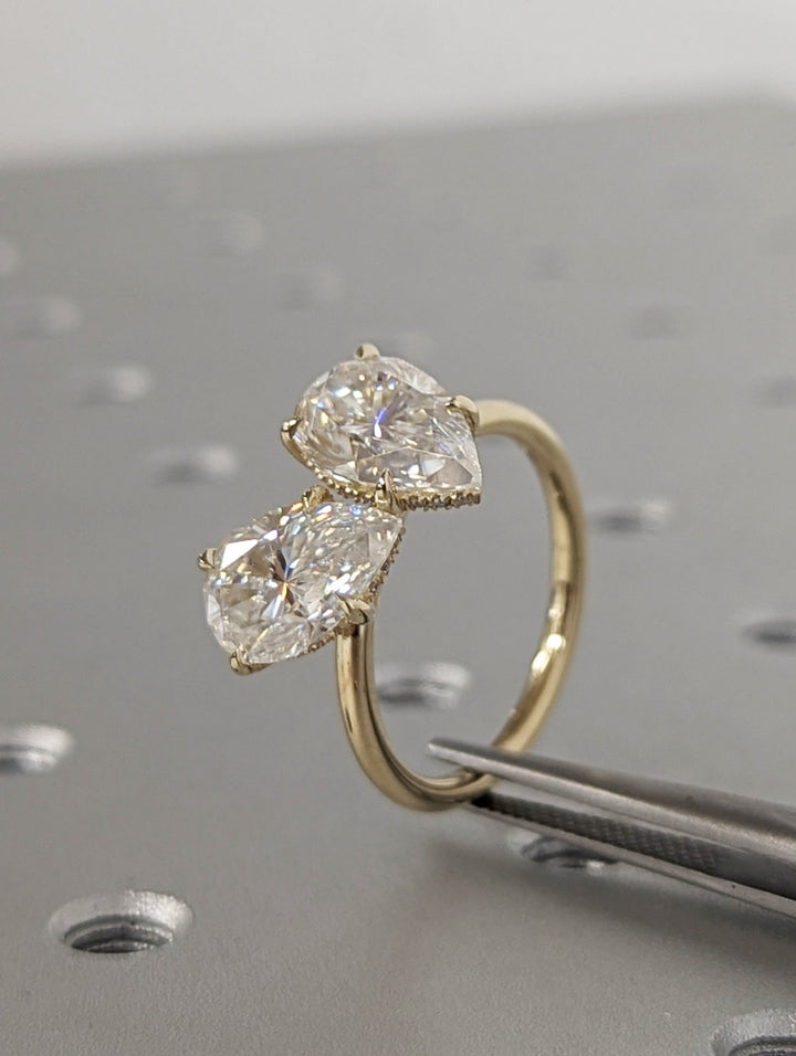 Pear hidden halo engagement ring viewed from the side