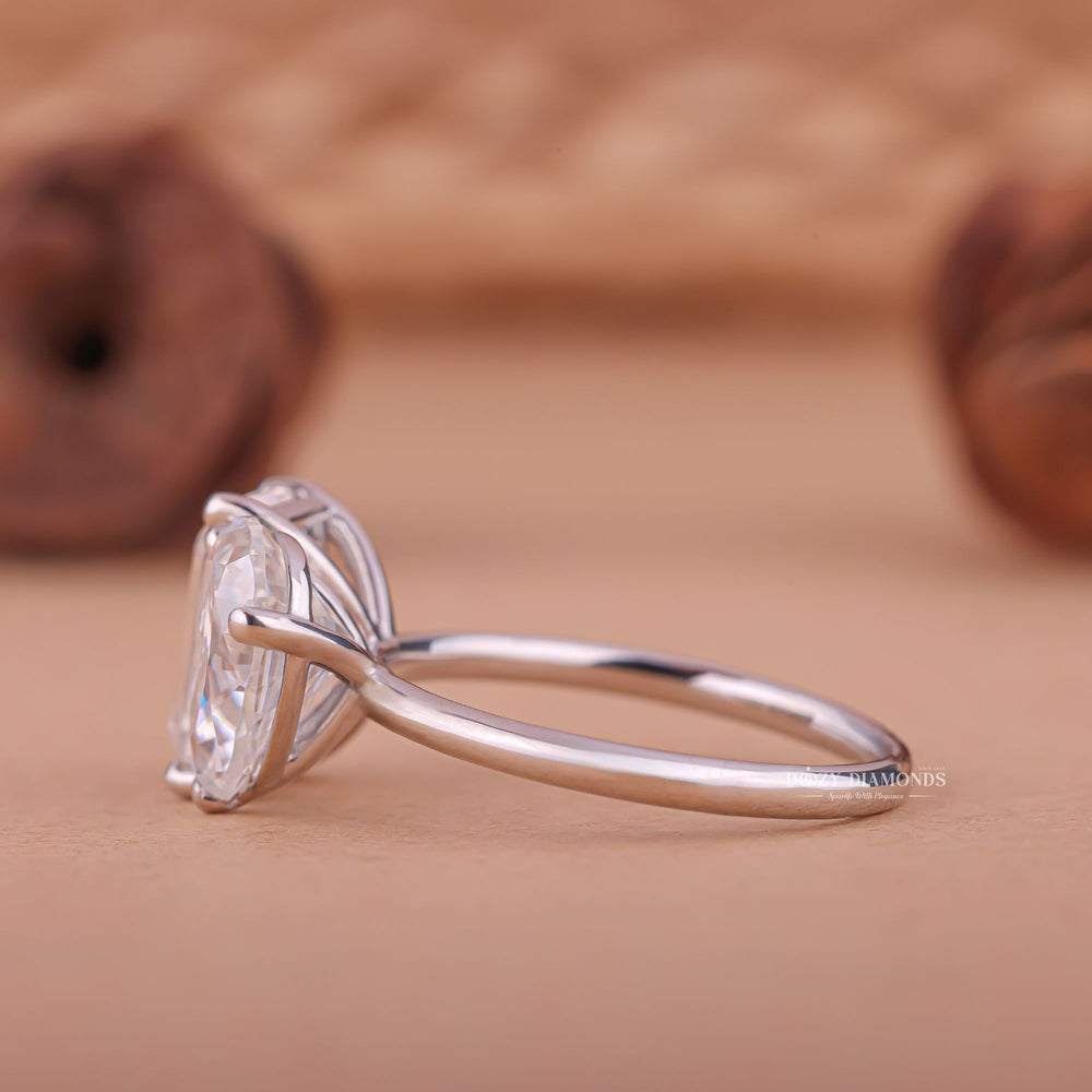 Pear solitaire diamond ring displayed on jewelry stand