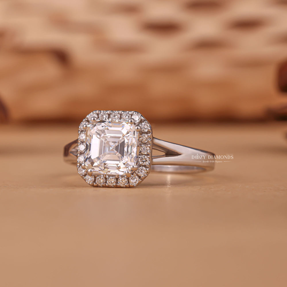 Close-up of asscher cut center diamond in halo engagement ring