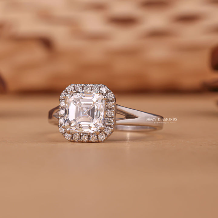 Close-up of asscher cut center diamond in halo engagement ring