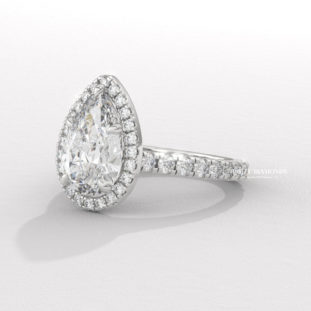 Pear cut engagement ring shown with authenticity certificate