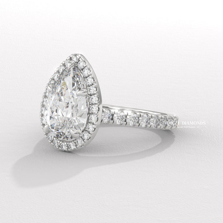 Pear cut engagement ring shown with authenticity certificate