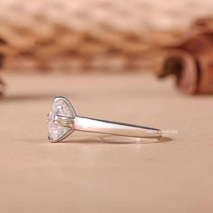 Asscher cut solitaire engagement ring shown in real-life wear