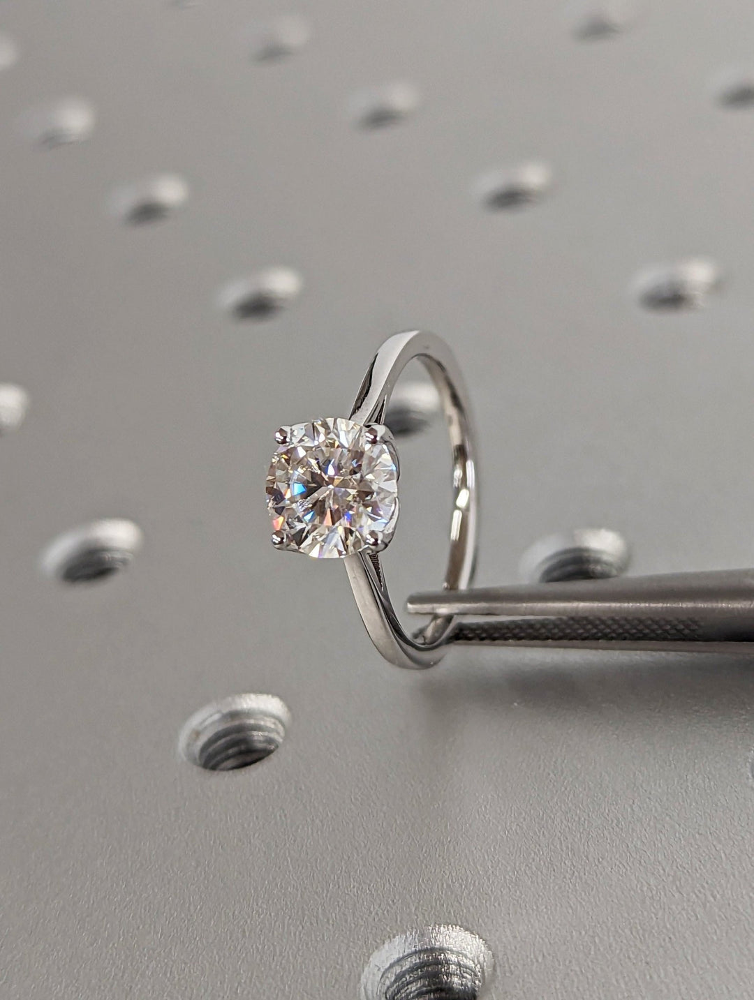 Macro shot of round cut diamond facets in solitaire ring setting