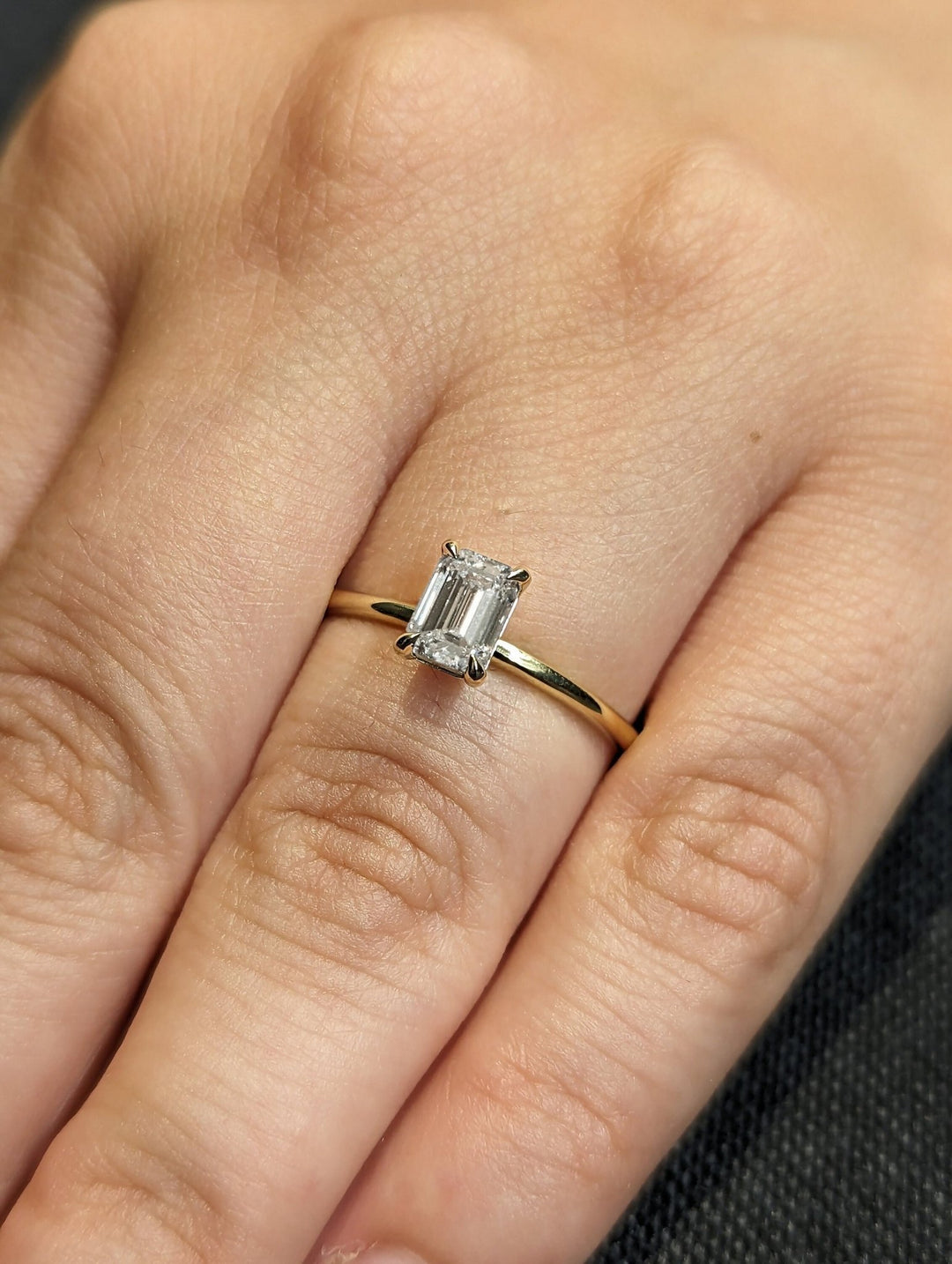 Profile view of emerald cut solitaire engagement ring band