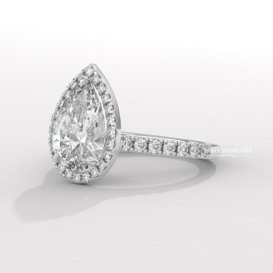 Pear halo engagement ring viewed from the side
