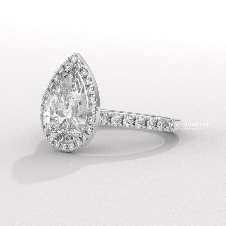 Pear halo engagement ring viewed from the side