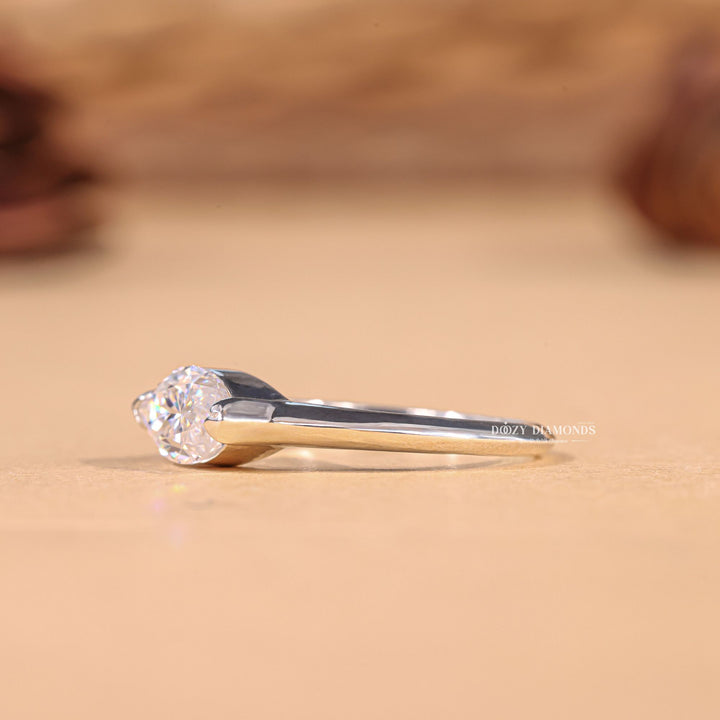 Marquise east west engagement ring shown on hand for true-to-life sizing