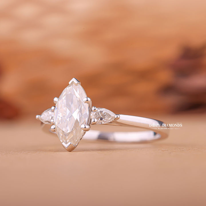 Unboxing view of marquise cut three stone diamond engagement ring