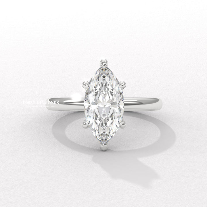 Certified marquise cut diamond featured in hidden halo engagement ring