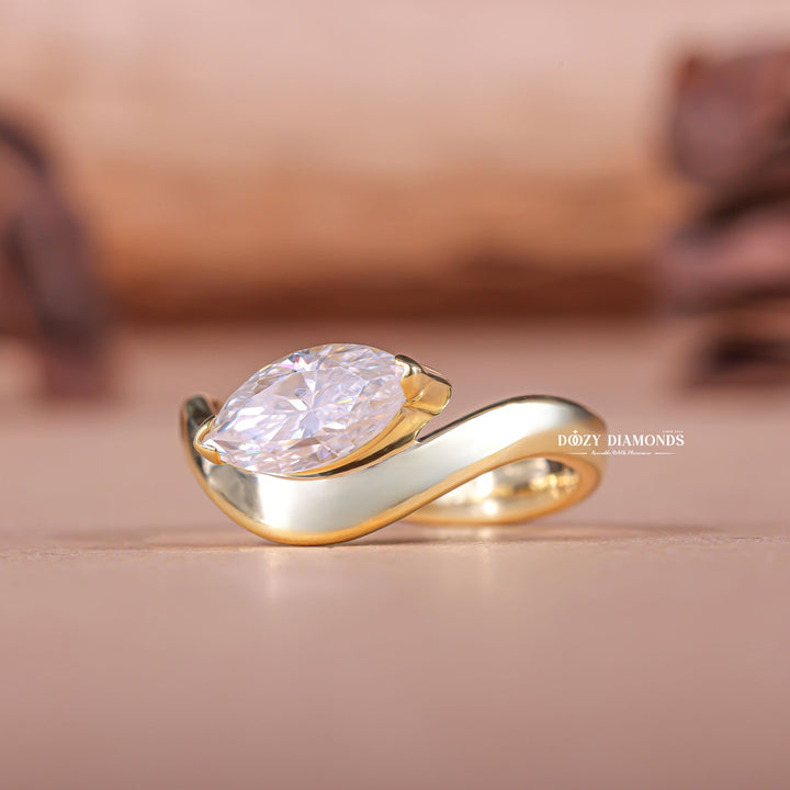 Marquise east west engagement ring offered in gold and platinum