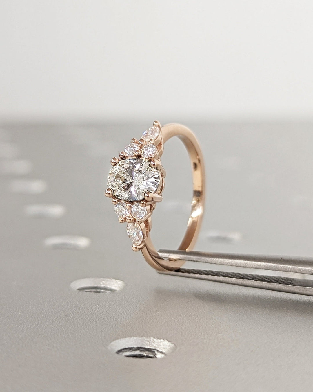 Oval cut cluster engagement ring with IGI certified center diamond