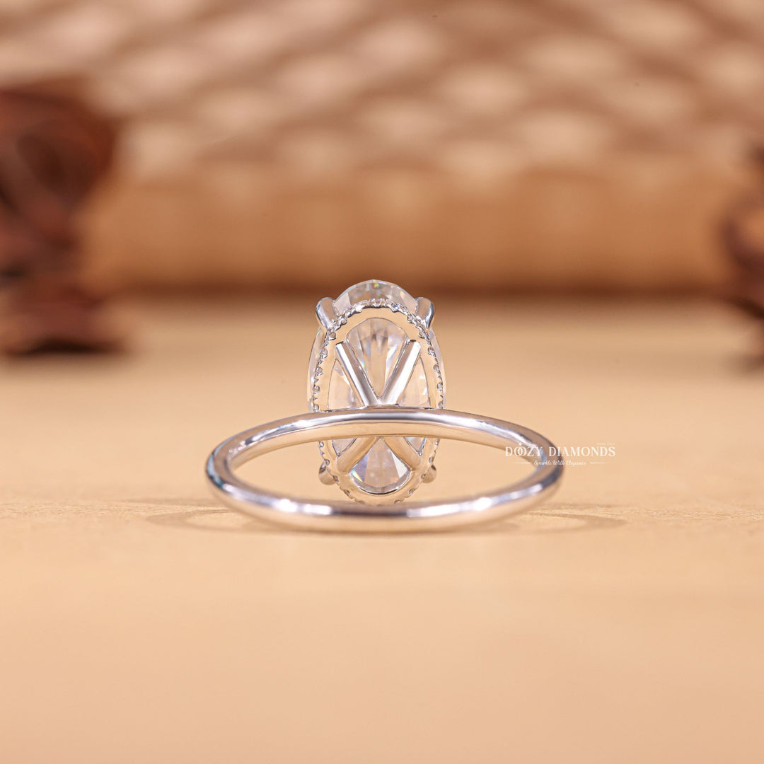 Oval hidden halo engagement ring finished in polished solid gold
