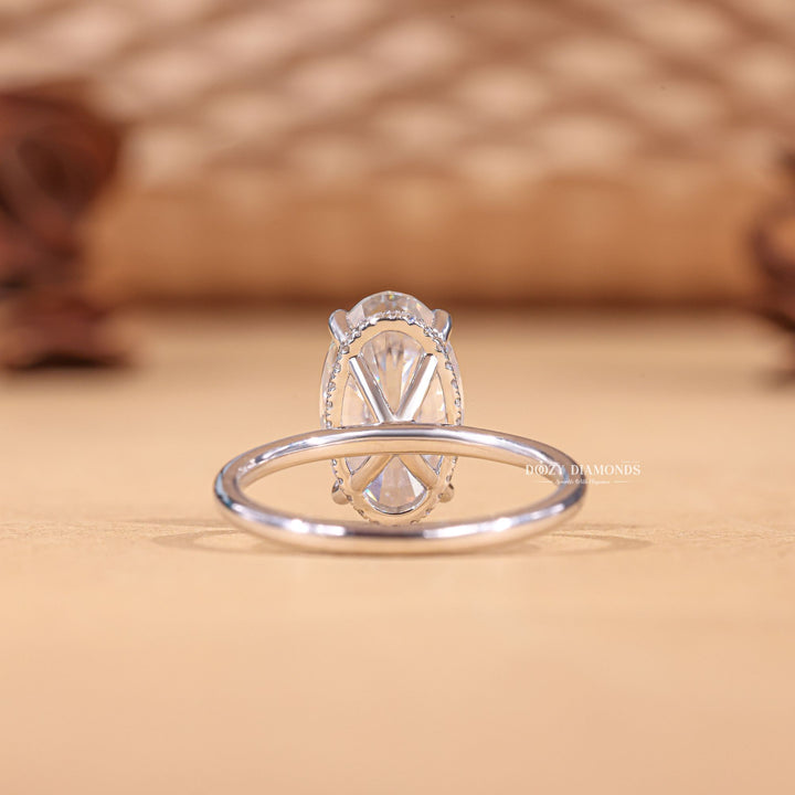 Oval hidden halo engagement ring finished in polished solid gold