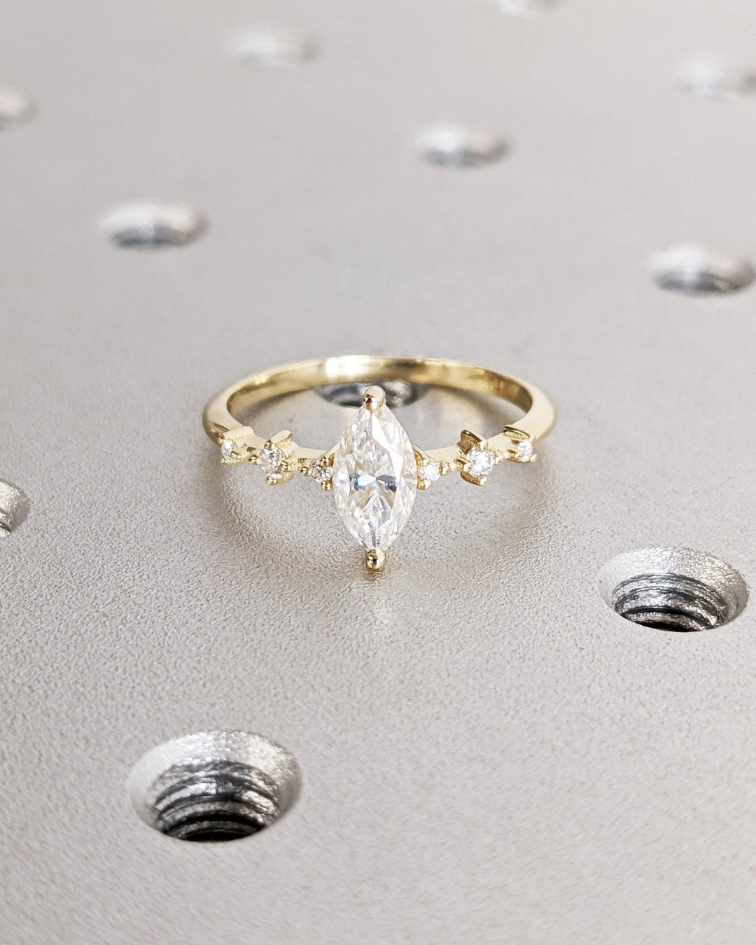 Close-up of marquise cut center diamond in pave engagement ring